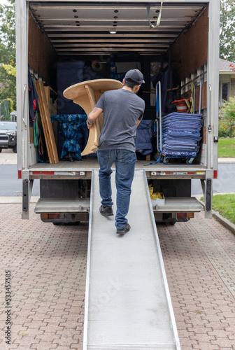 Professional mover carrying furniture photo