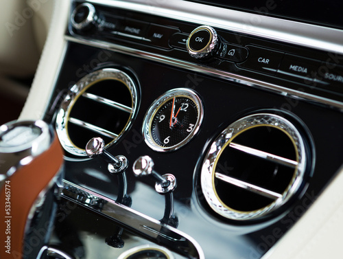 clock on the control panel in a very expensive car © AvokadoStudio