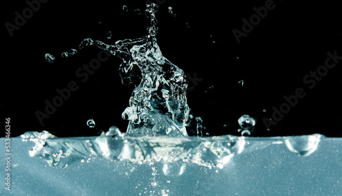 Clear water splash on black background with copy space