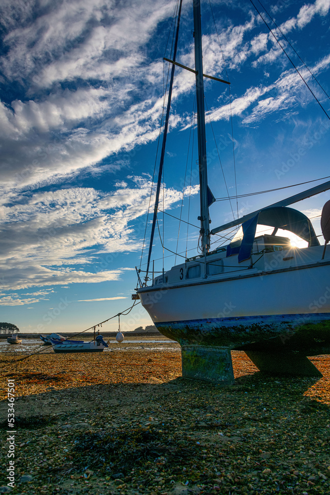 Stranded boats at sunset near Les Pierres Plates due low tide, Brittany, France Stranded boats at sunset near Les Pierres Plates due low tide, Brittany, France