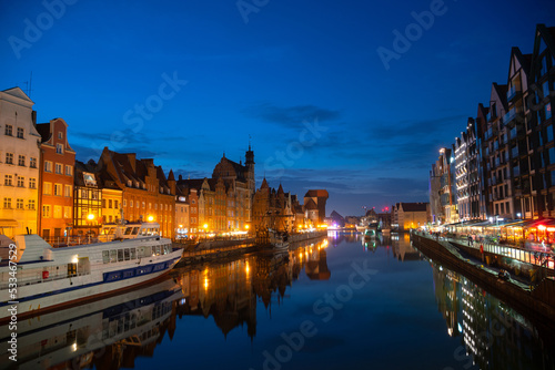 Scenic summer evening panorama of the architectural embankment pier canal river illumination of the Old Town GDANSK, POLAND