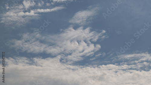 Fototapeta Naklejka Na Ścianę i Meble -  White curly clouds in the blue sky