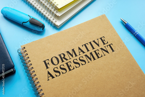 Formative Assessment guide and notebooks on the desk.