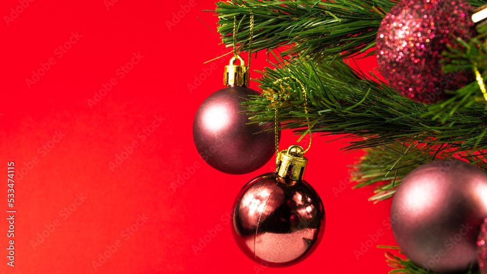 Christmas tree with shiny decorations on the red background. Christmas concept idea. Winter holiday season. Christmas tree with shiny decorations on the red background. Christmas concept idea. Winter holiday season.