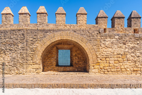 Aged masonry wall of fortress under blue sky photo