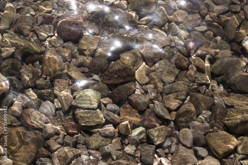 Top view of shining sunlight on Aegean sea and stones. Top view of shining sunlight on Aegean sea and stones.
