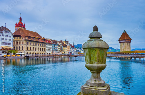 The stone urn on the embankment of Reuss river and view on Altstadt district of Lucerne city, Switzerland photo