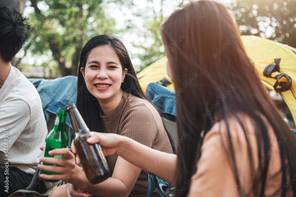 Group of friends at campground, Camping tent with friends, Diverse asian young people enjoying drinking beverage together at camp yard. Outdoor activity and leisure on holiday. Group of friends at campground, Camping tent with friends, Diverse asian young people enjoying drinking beverage together at camp yard. Outdoor activity and leisure on holiday.