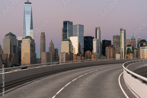 Empty urban asphalt road exterior with city buildings background. New modern highway concrete construction. Concept of way to success. Transportation logistic industry fast delivery. New York. USA.