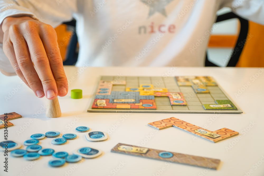 unrecognizable girl plays board game. leisure and fun free time unrecognizable girl plays board game. leisure and fun free time
