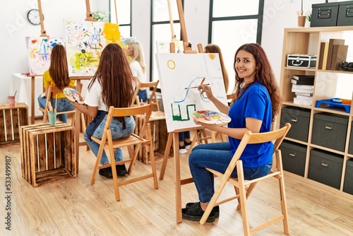 Group of young artist girls smiling happy drawing at art studio.