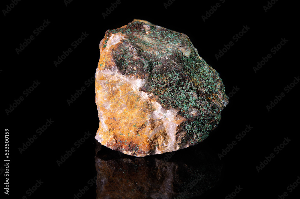 A piece of the raw mineral malachite of a yellow tint with a greenish coating A piece of the raw mineral malachite of a yellow tint with a greenish coating