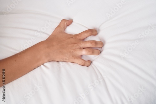 Young beautiful hispanic woman having orgasm on bed at bedroom