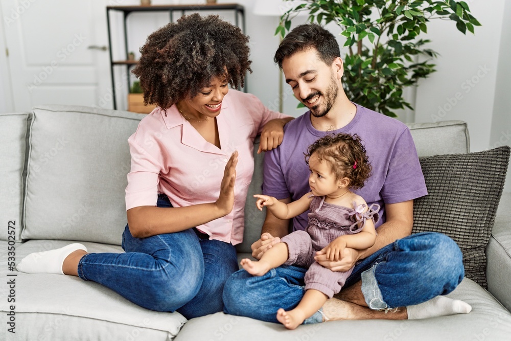 Couple and daughter smiling confident sitting on sofa at home Couple and daughter smiling confident sitting on sofa at home