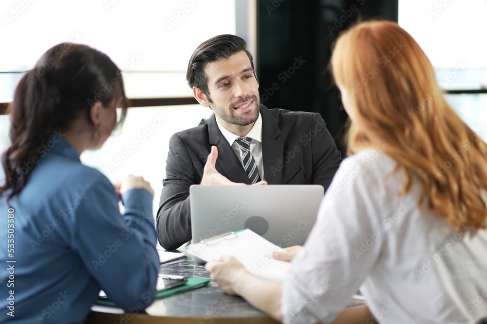 A group of business people are meeting to analyze data for marketing plan. Group of business people at conference.They discuss and train about new company projects. A group of business people are meeting to analyze data for marketing plan. Group of business people at conference.They discuss and train about new company projects.