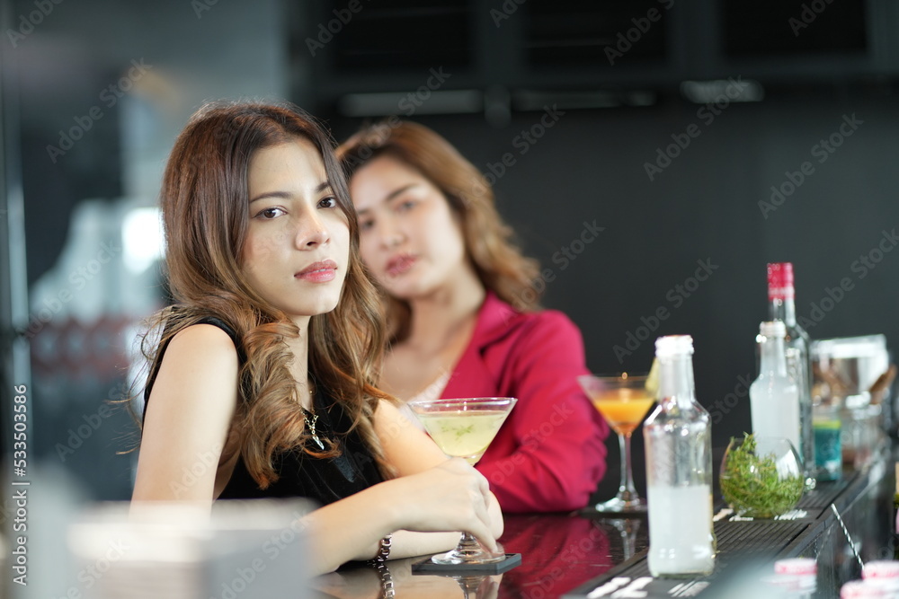 Pretty girl at night clubs. Photo of young women with cocktail in her hand in nightclub. Portrait of cheerful girl holding cocktail Pretty girl at night clubs. Photo of young women with cocktail in her hand in nightclub. Portrait of cheerful girl holding cocktail