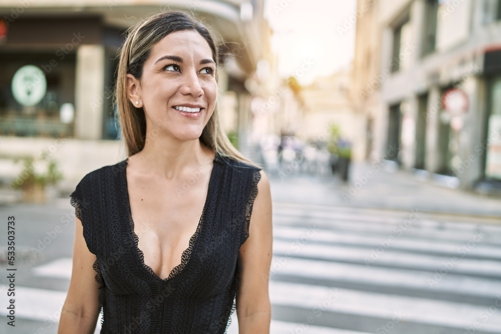 Young hispanic woman smiling confident at street