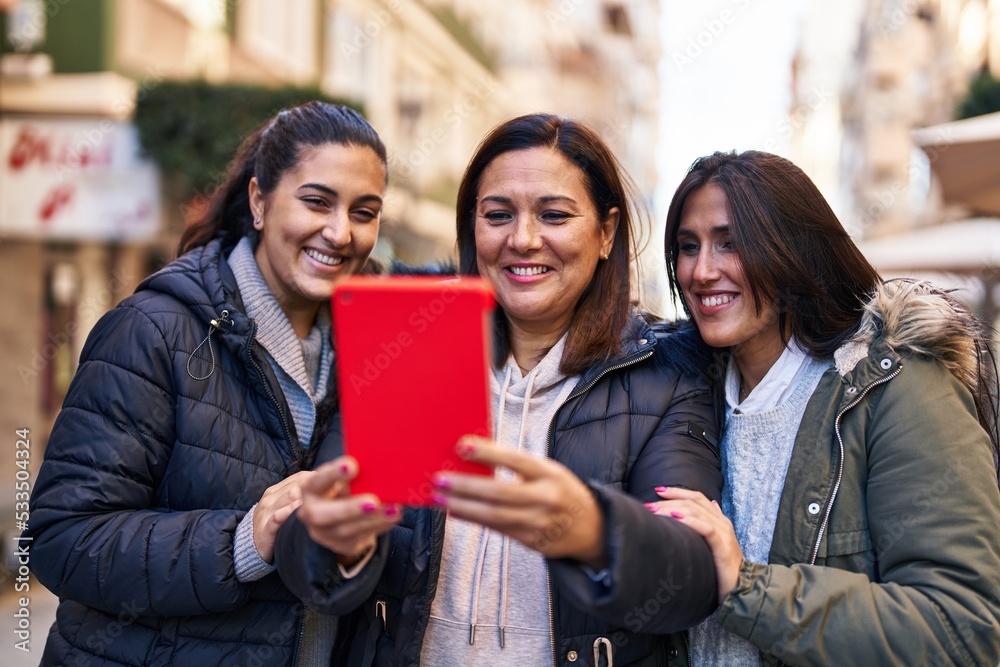 Three woman mother and daughters having video call at street Three woman mother and daughters having video call at street