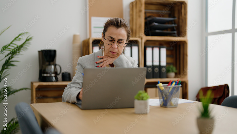 Middle age hispanic woman business worker working at office Middle age hispanic woman business worker working at office