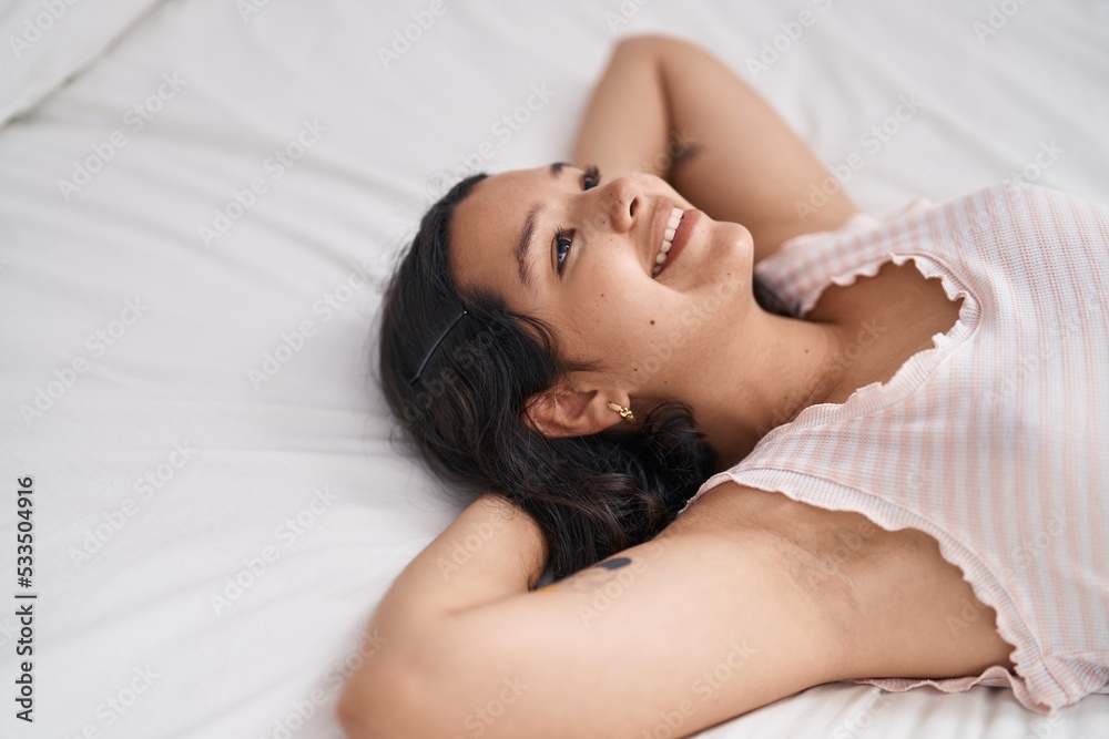 Young woman smiling confident relaxed on bed at bedroom Young woman smiling confident relaxed on bed at bedroom