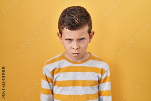 Wallpaper Mural Young caucasian kid standing over yellow background skeptic and nervous, frowning upset because of problem. negative person. Torontodigital.ca
