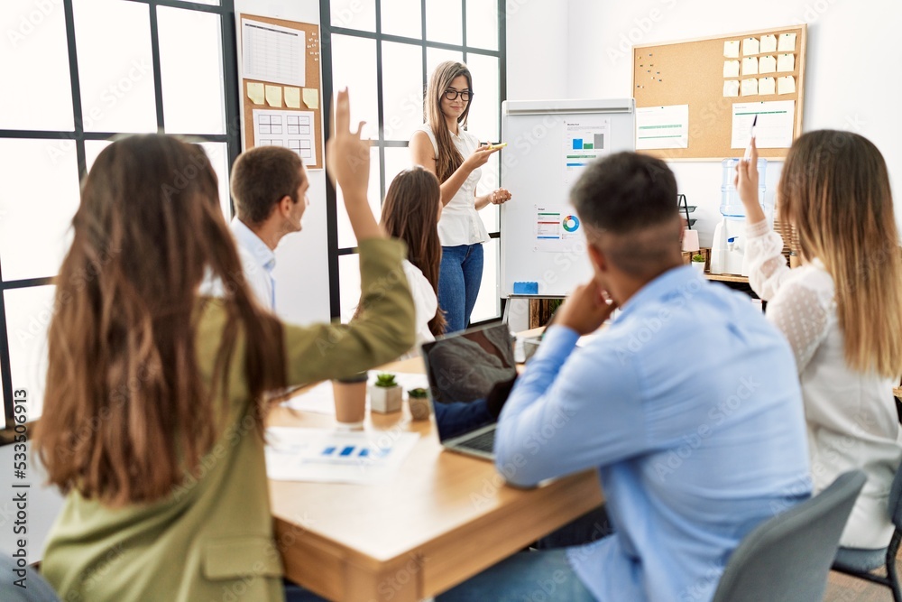 Group of business workers on chart board presentation at the office. Group of business workers on chart board presentation at the office.