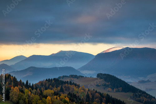 Beautiful sunrise in the mountainous rural landscape in autumn. The Mala Fatra national park in northwest of Slovakia, Europe.