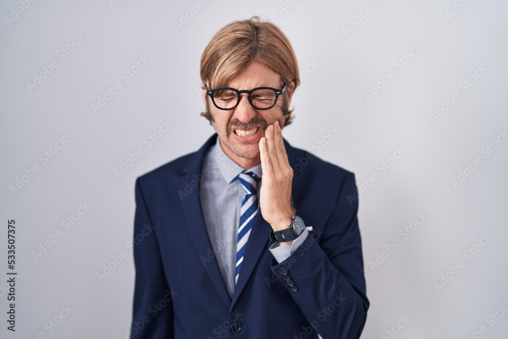 Caucasian man with mustache wearing business clothes touching mouth with hand with painful expression because of toothache or dental illness on teeth. dentist Caucasian man with mustache wearing business clothes touching mouth with hand with painful expression because of toothache or dental illness on teeth. dentist
