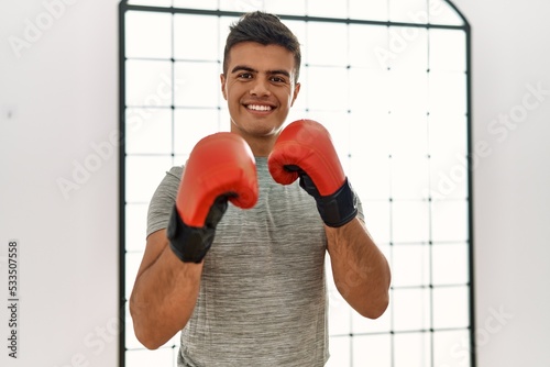 Young hispanic man smiling confident boxing at sport center © Krakenimages.com