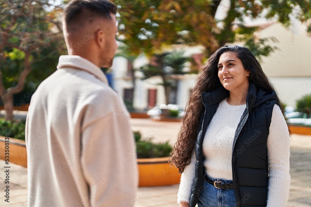 Man and woman couple smiling confident standing together at park Man and woman couple smiling confident standing together at park