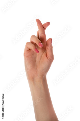 Woman hand with fingers crossed isolated on white