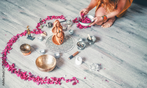 Beautiful altar with rose petals and goddess statuette. ceremony space.