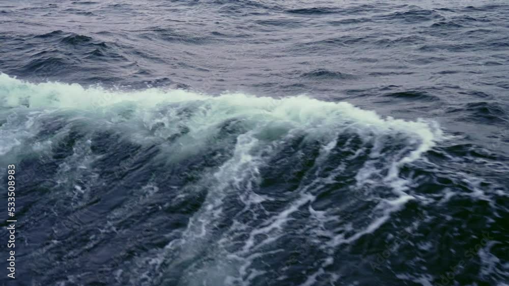 Close up with slow motion sea splash waves from sailing yacht. Dark sea waves Close up with slow motion sea splash waves from sailing yacht. Dark sea waves