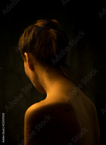 woman from behind between lights and shadows