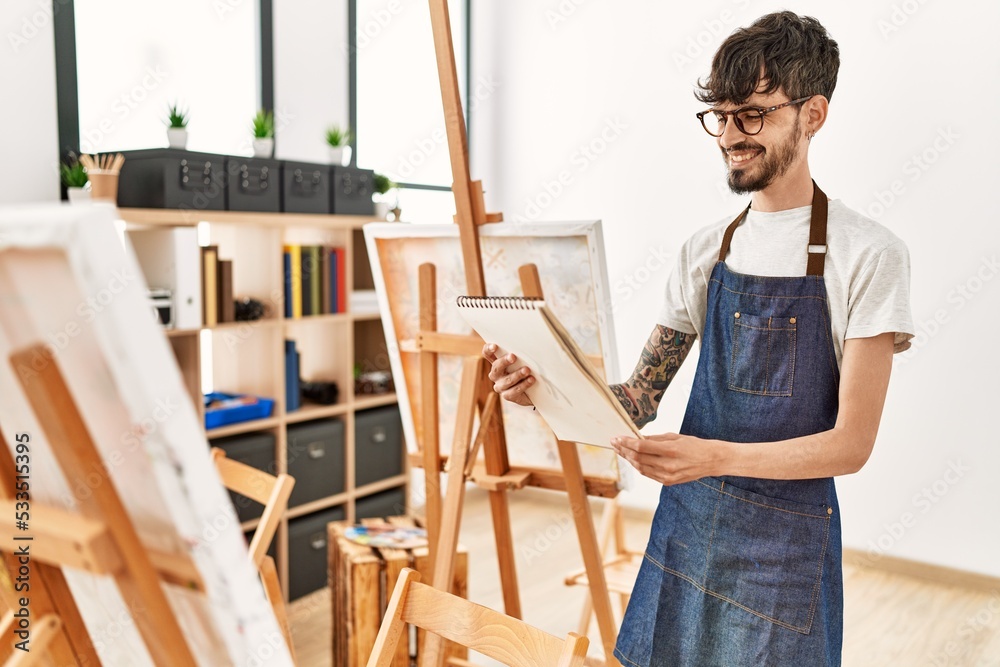 Obraz premium Young hispanic artist man smiling happy drawing at art studio.