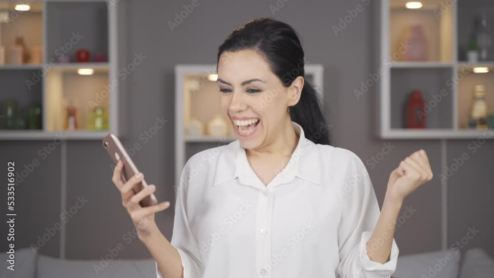 Attractive woman is rejoicing and happy.
The woman looking at the phone becomes happy and happy.
