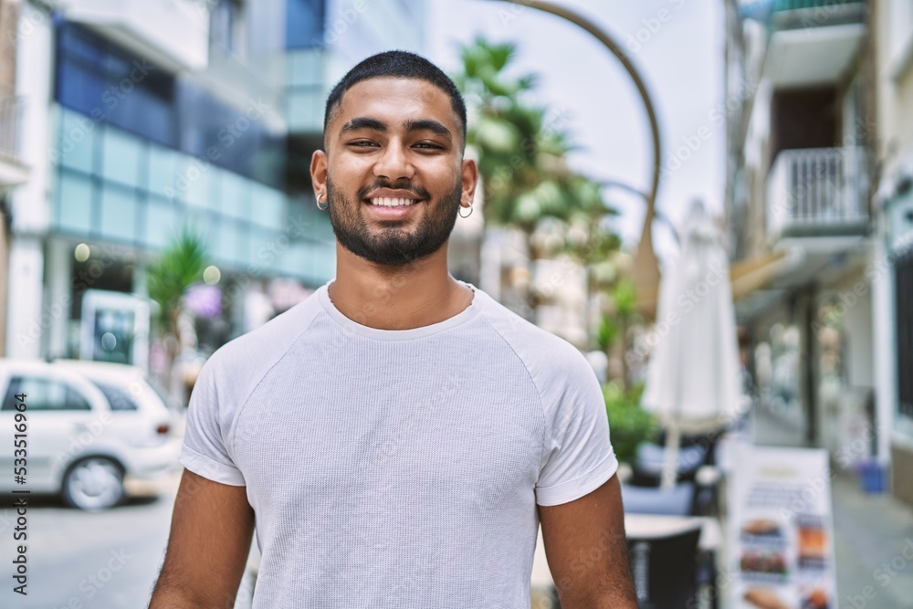 Young middle east man smiling happy standing at the city. Young middle east man smiling happy standing at the city.