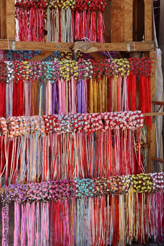 Handmade crowns with flowers and bows in a street stall of a medieval festival.