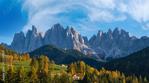 Autumn evening Santa Magdalena famous Italy Dolomites village surroundings in front of the Geisler or Odle Dolomites mountain rocks. Picturesque traveling and countryside beauty concept background. © wildman
