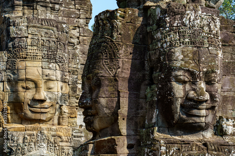 Cambodia. Siem Reap. The archaeological park of Angkor. Heads of Buddha sculpture at Bayon Temple 12th century Hindu temple
