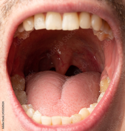 Tongue in open man mouth