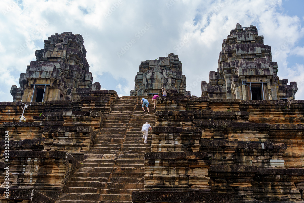 Cambodia. Siem Reap. The archaeological park of Angkor. People climb the steep stairs of Ta Keo Hindu temple