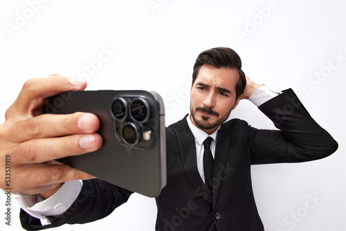 Man businessman holding the phone in his hand looking at him. Headache and anger from failure stress. Close-up wide angle photo white isolated background