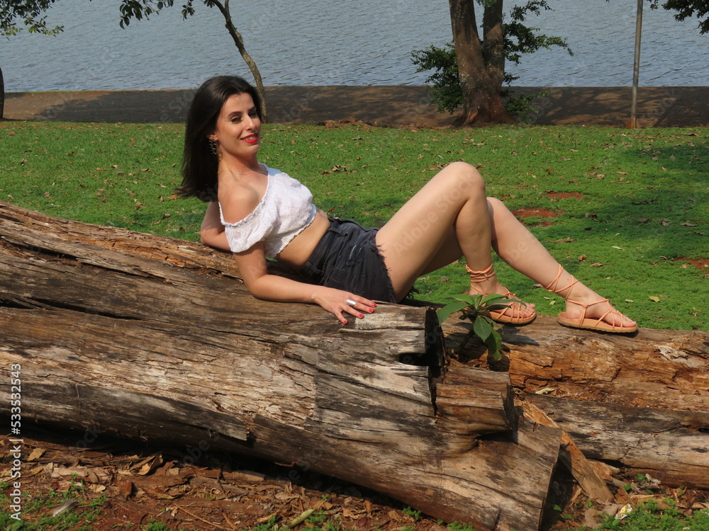 person sitting on a tree trunk person sitting on a tree trunk