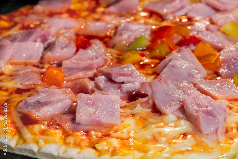 Baked pizza with ham, pepper, cheese, sause on tray in electric oven - close up macro view. Italian cuisine, background, fast food, cooking concept Baked pizza with ham, pepper, cheese, sause on tray in electric oven - close up macro view. Italian cuisine, background, fast food, cooking concept