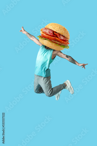 Jumping young man on color ...