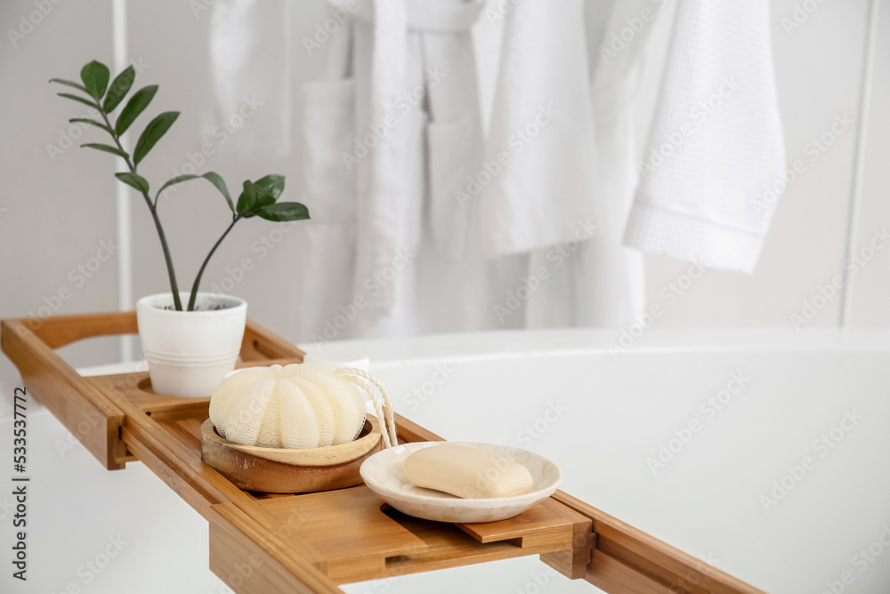 Wooden board with accessories on bathtub Wooden board with accessories on bathtub