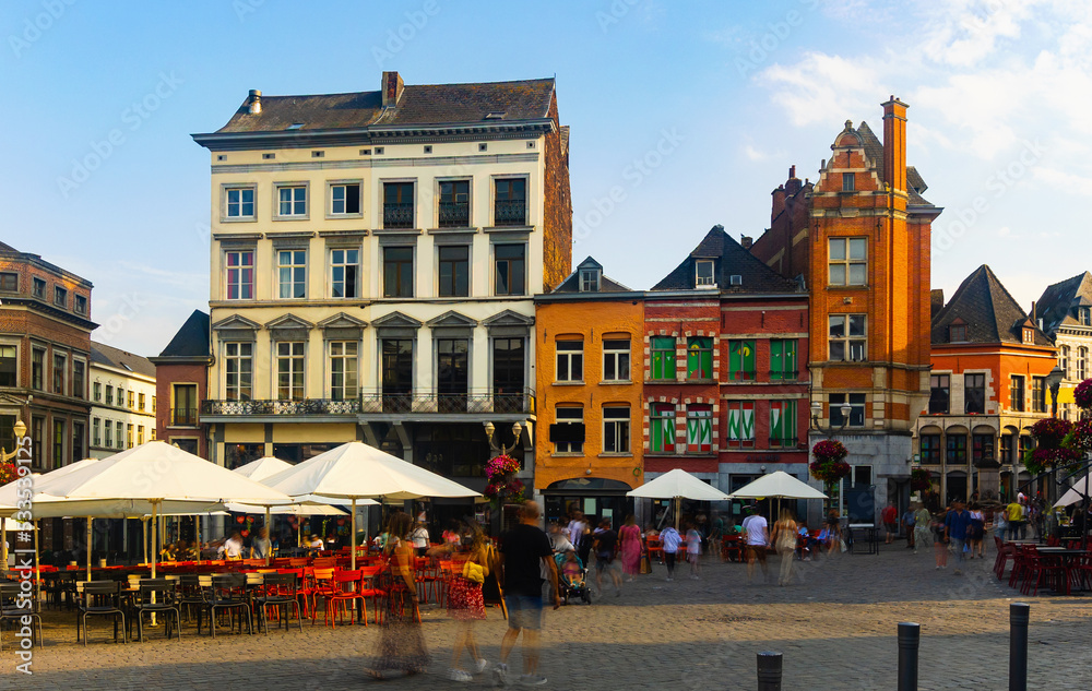 Scenic summer view of paved entirely with cobblestones and decorated with colorful facades lively Grand Place, main square in centre of old Belgian city of Mons, Wallonia