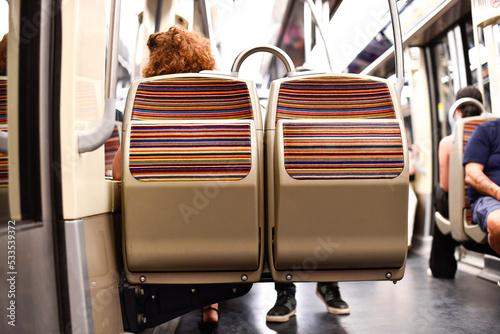 Fototapeta Naklejka Na Ścianę i Meble -  Illustration picture shows a close-up of empty seats inside a Parisian metro, (subway, metropolitain) in Paris, France. Blurred background with a view on the unrecognizable passengers.