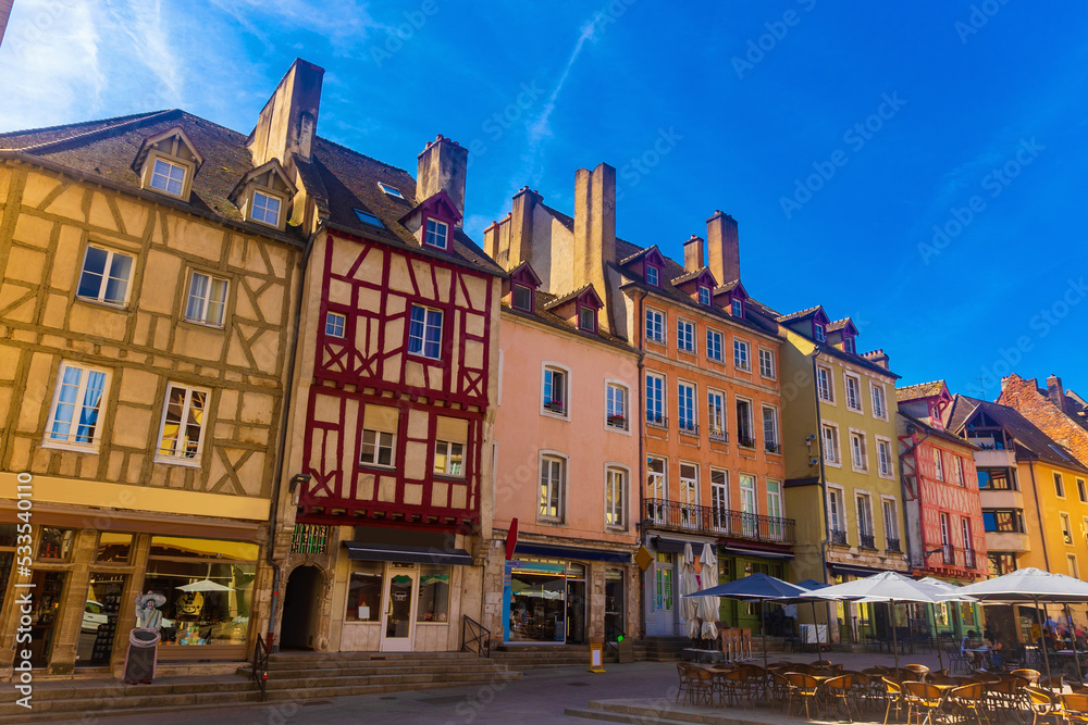 Summer streets of Chalon-sur-Saone under deep blue sky. View of half-timbered buildings. Saone-et-Loire department, France.